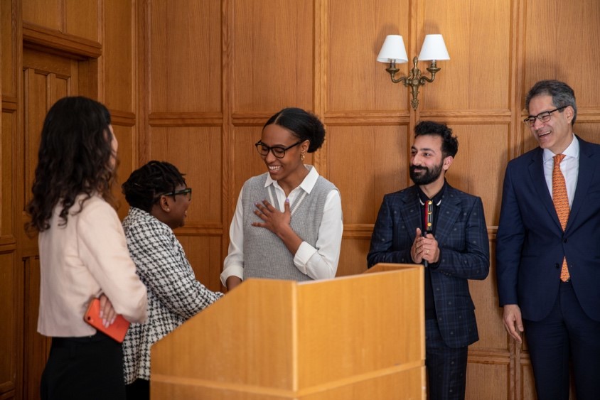 Maya McFarlane receiving her prize in the George Bridgetower room at Trinity Hall