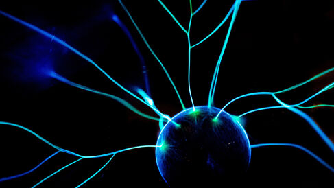 A glowing ball with streams of light flowing outwards